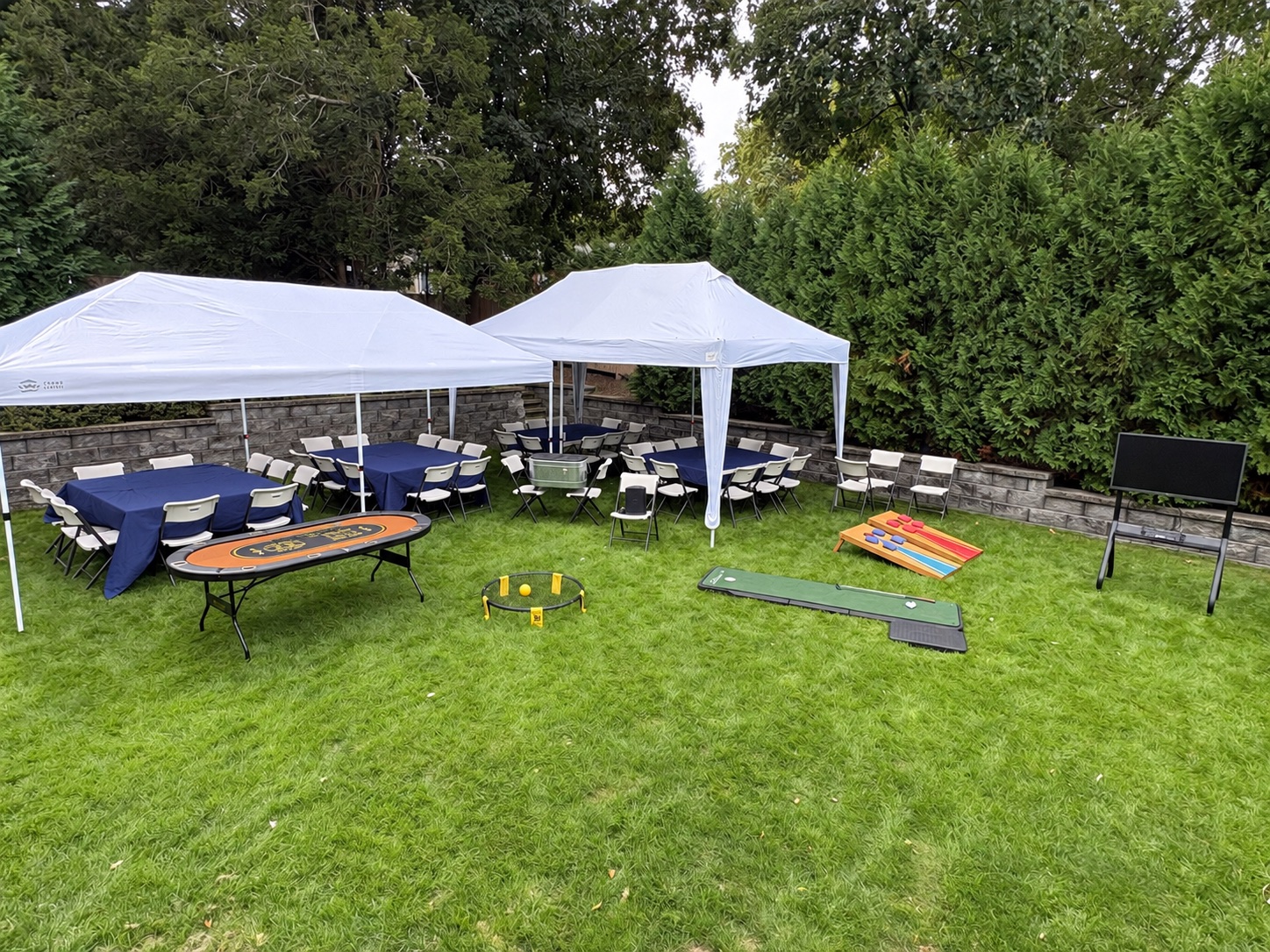 Backyard setup with optional poker, lawn games, and TV
