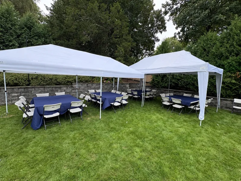 Two Bongo tents with tables and chairs; optional navy tablecloths are pictured