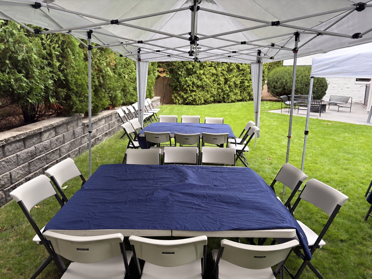 Navy tablecloths on folding tables beneath a Bongo tent